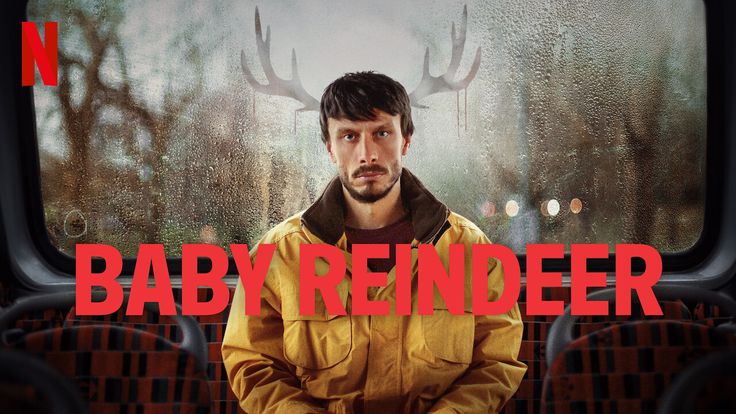 a man sitting in front of a window with the words baby reindeer on it