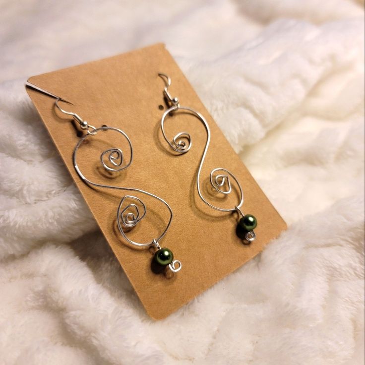 Wire Wrapped Hand Made Earring Metal Swirls Made With Aluminum Wire And Plastic Metallic Green Color Bead Black Heart Earrings, White Sapphire Earrings, Marcasite Earrings, French Hook Earrings, Ghost Earrings, Faux Pearl Earrings, Premier Designs Jewelry, Link Earrings, Handmade Wire Wrapped