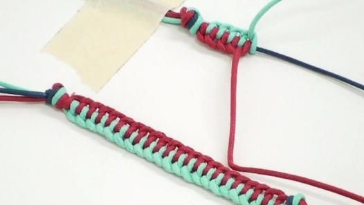 two pieces of red, green and blue string next to each other on a white surface