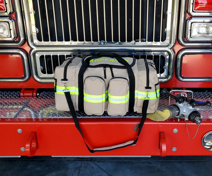 the back end of a firetruck with two bags on it's side