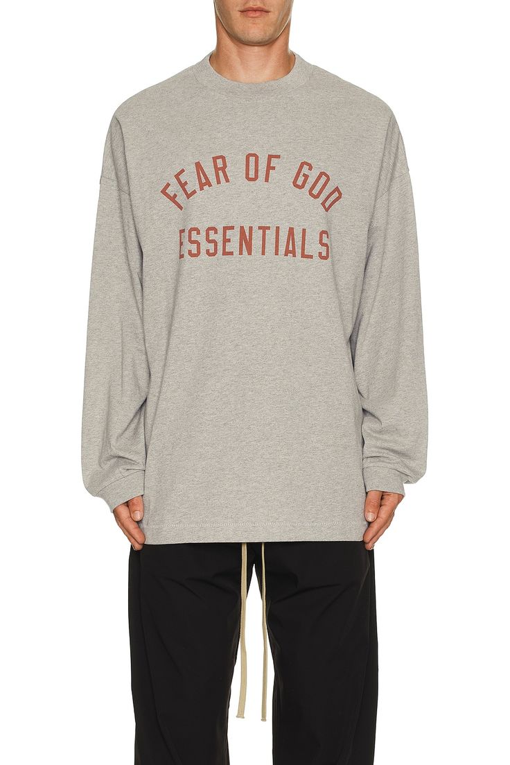 100% cotton.  Made in Vietnam.  Hand wash.  Front Fear Of God logo detail.  Back collar Fear Of God leather label.  Lightweight jersey fabric.  .  .  .  .  .  .  .  .  .  . Fear Of God Logo, God Logo, Fear Of God Essentials, Jersey Long Sleeve, Leather Label, Fear Of God, Long Sleeve Tee, Jersey Fabric, Vietnam