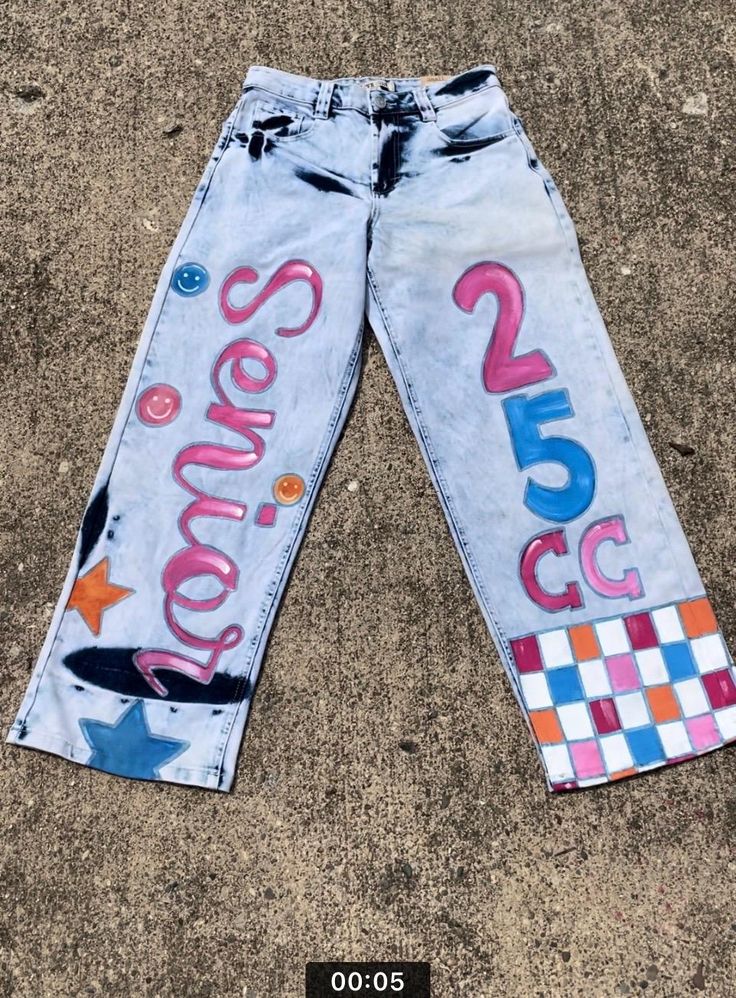 Handpainted jeans ready for spirit days, first days of school, and senior pictures! Senior Jeans Painted 2023 Back, Casual Hand Painted Blue Bottoms, Hand Painted Blue Jeans For Spring, Trendy Hand Painted Blue Jeans, Painted Spirit Jeans, Spirit Day Jeans, Homecoming Jeans Decorated, Painted Jeans School Spirit, Spirit Jeans Ideas