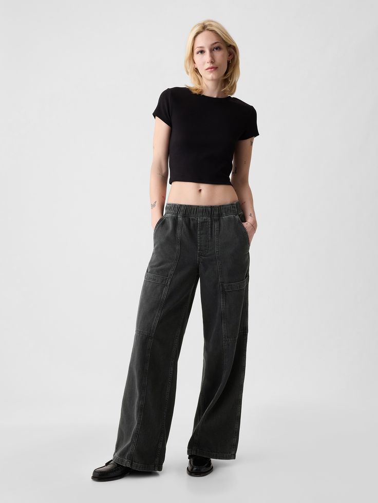 Fit: A full-length high rise jean that's loose throughout.  Finishes with a relaxed wide leg.  Fabric: 95% Cotton, 5% Recycled Cotton.  Stretch: No Stretch Jeans.  Authentic denim that gets better with every wear.  Made to wear all day & break in over time. ​ Rise: High Rise Skirt.  Look: A loose wide-leg utility jean in a black wash.  Details: Elasticized waist, front slant pockets, side cargo pockets, & back patch pockets.  Responsibly Made: This pair of jeans is part of our water-saving Washwell program.  Compared with conventional wash methods, Washwell uses at least 20% less water and has saved over a billion liters of water since 2016.  Our High Rise Jean has an 11" 28 cm) rise. ​ Loose through the hip & thigh.  Relaxed, wide leg.  Full-length jean.  Hits below the ankle.  Models wea Masc Girl, Europe Clothes, Black Wide Leg Jeans, Black Denim Pants, 90s Inspired Outfits, High Rise Skirt, Black Dress Formal, Water Saving, Vibe Clothes