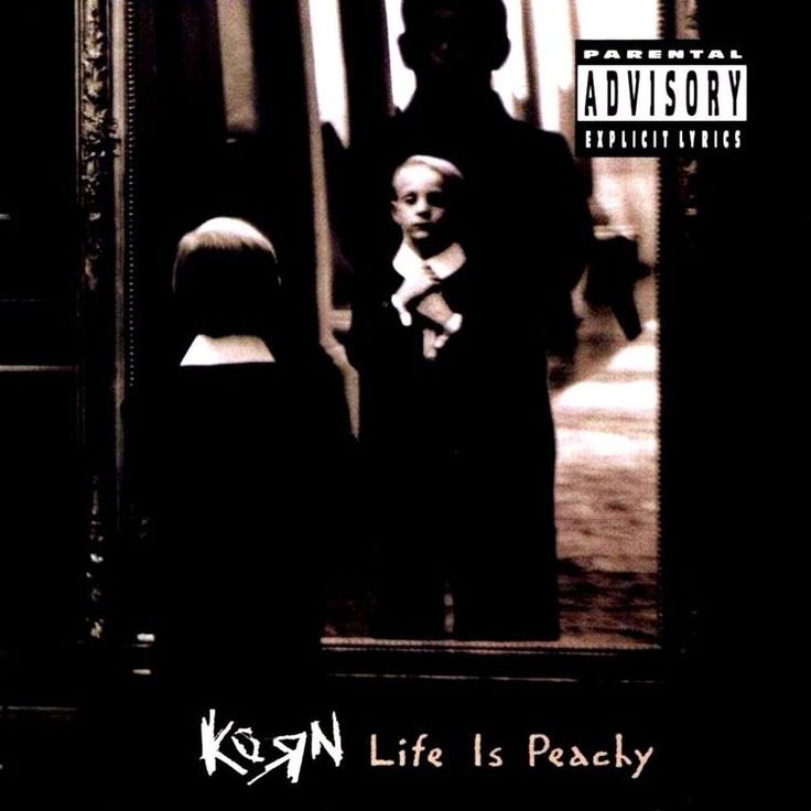 a black and white photo of two children in front of a mirror with the words korn life is peachy on it