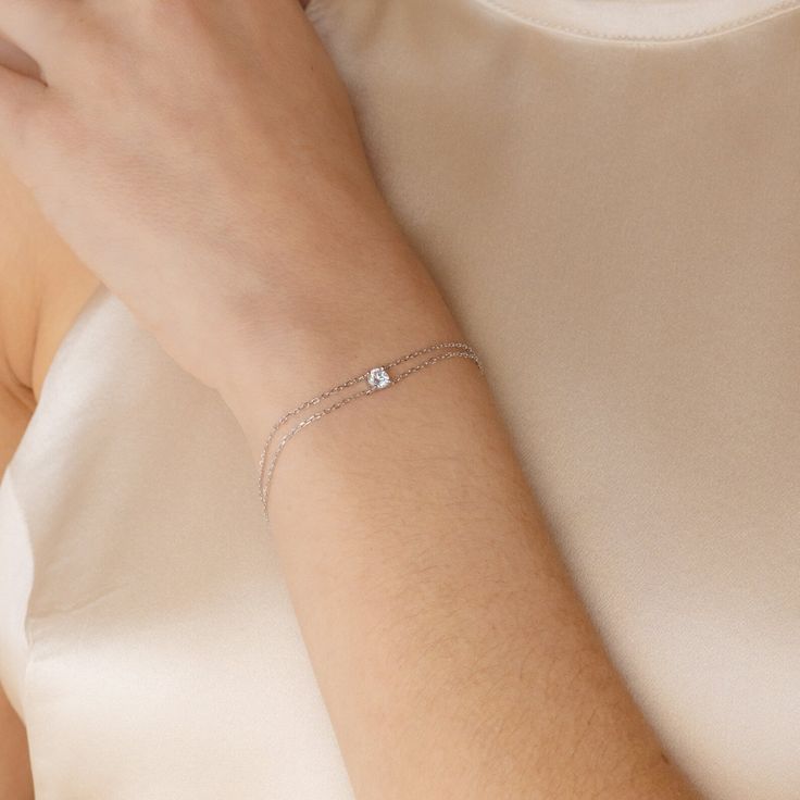 This Double Chain Diamond Bracelet is the perfect anniversary gift for your significant other. Featuring two delicate chains connected to a sparkling diamond charm, this minimalist bracelet will be her go-to accessory for everyday wear. Material: High Quality Solid 925 Sterling Silver Finish: Sterling Silver �∙ 18K Gold Featuring High Quality ~5mm CZ Diamond connected to 2 dainty Cable chains, adjustable from 6 to 8 inches SKU: RR-BR037 Aquamarine Stacking Ring, Initial Tag Necklace, Double Chain Bracelet, Duo Beads, Pearl Anklet, Chain Diamond, Sparkling Diamond, Beaded Anklets, Minimalist Bracelet