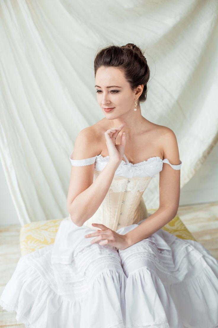 A set of Edwardian lingerie, which consists of the two-layered vanilla colour corset, white batiste camisolle and petticoat. The corset is made after original 1900s patterns and creates a fashionable S-curve silhouette. The bias cut of the details gives a better hold and fit. The corset has a central clasp and two stretchy garters. It's very comfortable to wear (tested!) and holds stockings so well that you forget about them by the beginning of the ball. The corset has steel boning and can reduc Victorian Bodice With Corset Back For Wedding, Victorian Overbust Wedding Bodice, Victorian Wedding Bodice With Corset Back, Victorian Wedding Dress With Underbust Style, Elegant Underbust Corset With Lace Trim, Vintage Victorian Dress With Boned Bodice, Victorian Underbust Wedding Bodice, Delicate Lace Fitted Bodice Corset, Wedding Corset With Delicate Lace