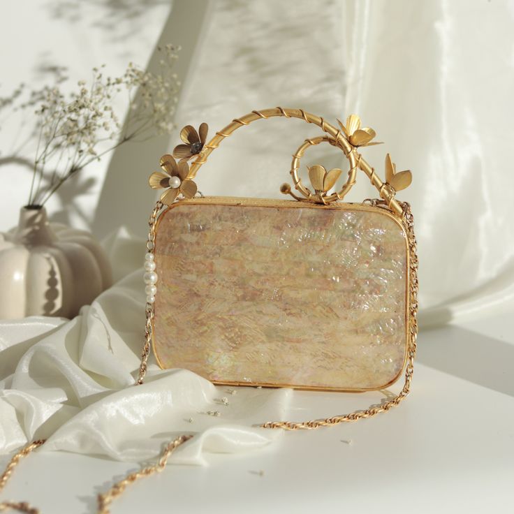 Luxury Mother of Pearl Shell Minaudiere Clutch Purse Elevate your evening look with our stunning Mother of Pearl Shell Minaudiere Clutch--a luxurious fan-shaped evening bag perfect for weddings, engagements, Diwali, Christmas, baby shower and other special occasion. Crafted from high-quality mother of pearl sourced from the Indian Ocean, this unique clutch is both a fashion statement and a timeless accessory. Elevate your style with this stunning ocean-inspired mini seashell handbag, meticulousl Designer Bag With Detachable Strap For Gift, Designer Pouch Box Bag For Gifts, Elegant Box Bag With Removable Pouch For Gift, Gift Rectangular Box Bag With Removable Pouch, Gift Box Bag With Removable Pouch In Rectangular Case, Designer Square Box Bag For Gifts, Designer Rectangular Case Bag For Party, Designer Rectangular Case Party Bag, Designer Handheld Bag As Gift