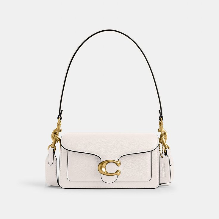 A modern take on an archival 1970s Coach design our structured Tabby shoulder bag is crafted of polished pebble leather. Smaller than the 26 the petite 20 features two detachable straps to carry by hand style as a short shoulder bag or wear crossbody. It’s finished with our Signature hardware for an iconic touch. | Coach Tabby Shoulder Bag 20 - Women's - Brass/chalk Classic Satchel Baguette Bag With Metal Hardware, Modern Coach Shoulder Bag With Gold-tone Hardware, Timeless Coach Shoulder Bag With Gold-tone Hardware, Chic Coach Flap Bag With Adjustable Strap, Classic Coach Shoulder Bag For Evening, Chic Coach Shoulder Bag With Adjustable Strap, Classic Coach Evening Shoulder Bag, Elegant Coach Baguette Bag With Detachable Strap, Timeless Coach Satchel Shoulder Bag