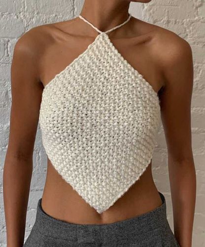 a woman wearing a white crochet halter top