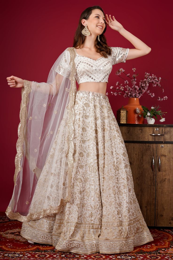 This Lehenga Choli is Ready to Wear Elevate your style with our Gorgeous White Color Georgette Embroidered Zari Sequin And Bead Lehenga Set. attached cancan lehenga with sequins embroidery. This stunning party wear features intricate embroidery, shimmering sequins, and delicate beadwork, all on high-quality georgette fabric. Perfect for special occasions, this set is sure to turn heads and make you feel like the center of attention. Comes with heavy embellished padded blouse & sequins beads and Navratri Organza Embroidered Gown, Navratri Embroidered Organza Gown, Embroidered Organza Gown For Navratri, Pearl Embroidery Sharara For Diwali, Eid Reception Lehenga With Sequins, Sequin Lehenga For Eid Reception, Party Traditional Wear With Pearl Embroidery, White Sequin Sets For Eid, Sequin Fabric For Receptions And Festivals