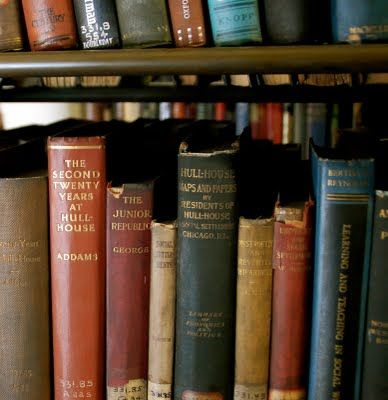 an assortment of books on a shelf in a library