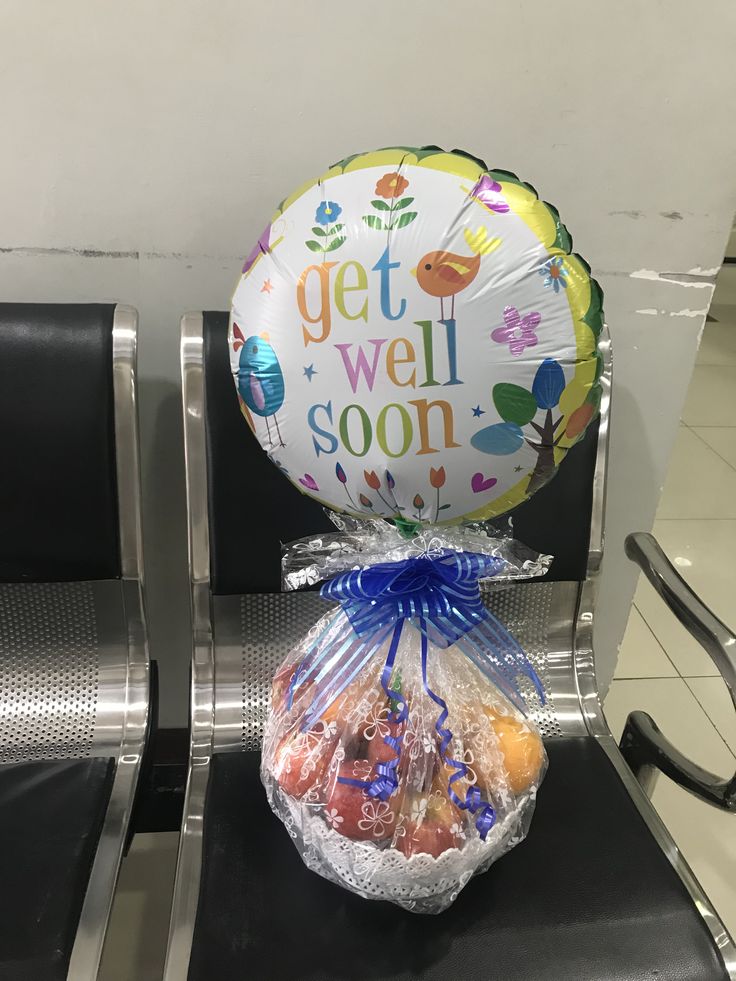 a balloon sitting on top of a chair next to a bag filled with cookies and candies