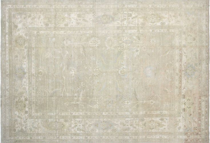 an antique rug with white and beige colors on the ground, in front of a white background