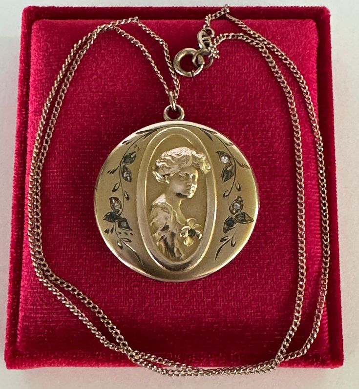 Rare and substantial antique circa 1900s Victorian era gold filled gibson girl portrait locket! This stunning pendant features a repousse woman's portrait facing to the right with ten clear paste stones, she's holding a flower with a green stone in the center. The locket hangs from its original chain. A phenomenal piece of fine Victorian jewelry, featuring a beautiful gibson girl!  ERA - Circa 1900s - Victorian  METAL / MATERIAL - Gold filled, rhinestone paste stones MARKINGS / HISTORY - Chain is marked Barrows 12k 1/15  (Barrows Jewelry is one of the oldest and most respected  jewelry stores in the country. They have been in business since 1851) CONDITION - Good antique condition. Gold filled metal has been polished & cleaned. Very little age appropriate patina & wear remains - a few mino Antique Yellow Gold Medallion Locket Necklace, Antique Style Yellow Gold Medallion Locket Necklace, Antique Medallion Locket Necklace Stamped 14k, Vintage Collection Cameo Medallion Locket Necklace, Antique Cameo Medallion Locket Necklace, Cameo Medallion Locket Necklace, Gold Cameo Locket Necklace Collectible, Vintage Medallion Cameo Locket Necklace, Victorian Locket Necklaces For Vintage Events