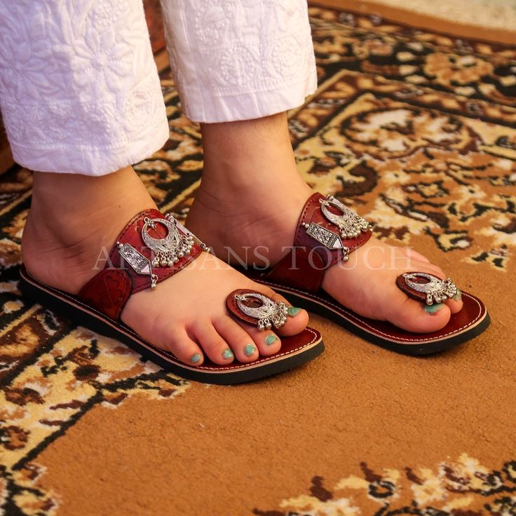 Handcrafted Leather Ethnic Slipper with Silver Toe Ring Detailing - Women's Silver Toe Ring Slippers  Description:  Step into a world of timeless elegance and comfort with our exquisite Handcrafted Leather Ethnic Slipper adorned with silver toe ring detailing, exclusively designed for women who appreciate style and tradition. These meticulously crafted slippers are the perfect blend of fashion, culture, and comfort, making them an essential addition to your footwear collection.  🌟 Key Features:  ✨ Handcrafted Excellence: Our skilled artisans put their heart and soul into creating each pair of these leather ethnic slippers. The result is a masterpiece of craftsmanship, featuring intricate detailing that reflects the rich heritage of traditional footwear.  ✨ Silver Toe Ring: The highlight o Traditional Adjustable Toe Post Sandals, Traditional Hand-tooled Open Toe Huarache Sandals, Traditional Hand-tooled Brown Sandals, Traditional Brown Hand-tooled Sandals, Traditional Leather Barefoot Sandals With Adjustable Fit, Traditional Closed Toe Barefoot Sandals, Festival Toe Ring Sandals With Open Toe, Traditional Sandals With Adjustable Single Toe Strap, Traditional Hand Tooled Closed Toe Sandals