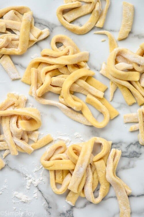 some uncooked pasta on a marble counter top