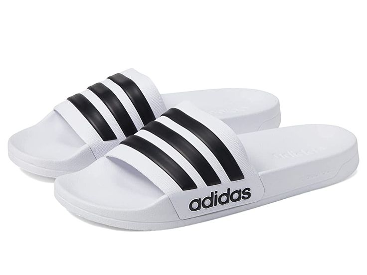 adidas Adilette Shower - Shoes : White/Black/White : Get yourself the trendy adidas Adilette Shower slippers. Synthetic upper, lining and insole. adidas logo on toe strap. Slip-on closure. Synthetic outsole. Imported. Measurements: Weight: 4 oz Product measurements were taken using size Men's 10, Women's 11, width Medium. Please note that measurements may vary by size. Adidas Slides For Swimming In Summer, Adidas Slides For Summer Swimming, Adidas Sporty Slides For Summer, Adidas Sporty Summer Slides, Adidas Synthetic Slides For Swimming, Adidas Slides For Swimming With Synthetic Material, Adidas Slides For Swimming With Logo, Adidas Logo Synthetic Slides For Swimming, Adidas Non-slip Beach Slides