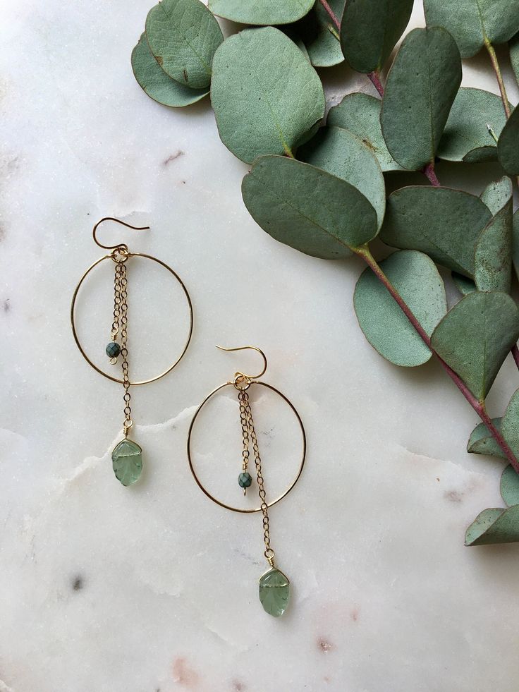 HOLIDAY ORDER DEADLINE: Orders placed after December 18 will not be shipped until January 3!  Clear aqua, green, or turquoise leaf chain dangles on a gold wire hoop. Including the ear wire, they are 3in long by 1 1/8in wide. Made with gold plated wire; wire wrapped detail to secure the hoop is attached to an elegant ear wire. If you have allergies that restrict which metals you can wear, please send me a message first before purchasing. Visit poppyjewelrydesigns.com for more inventory and new st Green Long Drop Jewelry With Dangling Beads, Green Wire-wrapped Dangle Hoop Earrings, Green Wire Wrapped Dangle Hoop Earrings, Green Dangle Metal Hoop Earrings, Green Dangle Hoop Earrings In Metal, Green Metal Dangle Hoop Earrings, Green Teardrop Chandelier Earrings Nickel Free, Green Nickel Free Dangle Chandelier Earrings, Green Teardrop Nickel-free Chandelier Earrings