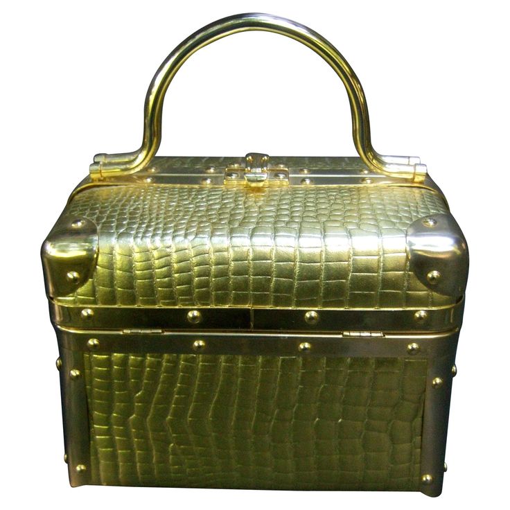 Borsa Bella Italy gold metallic embossed box purse c 1980s The stylish Italian box purse is covered with luminous gold embossed vinyl that emulates reptile skin Designed with a pair of gilt metal swivel handles Framed with sleek gilt metal trim. The interior is lined in brown felt with Borsa Bella Italy repeated throughout Makes a very striking accessory Measurements The length from side to side = 8 inches The height from the lid cover to the handbag base = 6 inches The drop length from top of t Handmade Leather Purse, Leather Bag Design, Leather Handbags Handmade, Box Purse, Versace Handbags, Green Handbag, Metallic Purse, Couture Handbags, Diy Purse