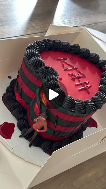 a red and black cake in a white box on a wooden table with the words happy valentine's day written on it