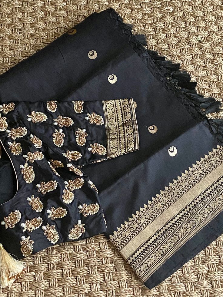 "❤️❤️❤️ Royal Black Banarasi Katan ❤️❤️❤️ Absolutely Gorgeous Unique Designer Pure Katan silk saree with all over Chaand Tara ( Ek Taara) woven kaduwa Butties and kaddi borders. The Saree has woven Kaddi Borders and Amazing Pallu with Geometric patterns of weaving in Antique Gold Zari. Perfect outfit for a Date Nights or for any Formal Events. Pair it up with a simple Black or a Golden clutch to make this look more Stunning. *Fall, Pico & Tassels : Done *Condition : New Saree With Stitched Blous Black Silk Embroidered Saree Fabric, Black Silk Fabric With Zari Embroidery, Black Art Silk Embroidered Saree Fabric, Black Embroidered Art Silk Saree Fabric, Black Raw Silk Saree Blouse Piece, Designer Black Raw Silk Saree, Designer Black Katan Silk Blouse Piece, Festive Black Tussar Silk Blouse Piece, Black Katan Silk Blouse For Designer Wear