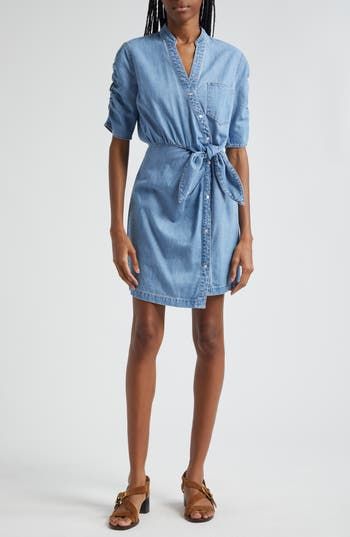 Ruched sleeves and a front tie detail put a contemporary spin on a nonstretch denim shirtdress in a mini length. 33 1/2" length Front snap closure Band collar Elbow-length sleeves Attached waist tie 100% cotton Dry clean Imported Belted Denim Dress For Summer Workwear, Denim Knee-length Shirt Dress For Work, Denim Button-up Mini Dress For Work, Button-up Denim Mini Dress For Work, Spring Relaxed Fit Shirt Dress With Tie Waist, Spring Shirt Dress With Tie Waist And Relaxed Fit, Spring Short Sleeve Shirt Dress With Tie Fastening, Short Sleeve Shirt Dress With Tie Fastening For Spring, Fitted Shirt Dress With Tie Waist For Spring