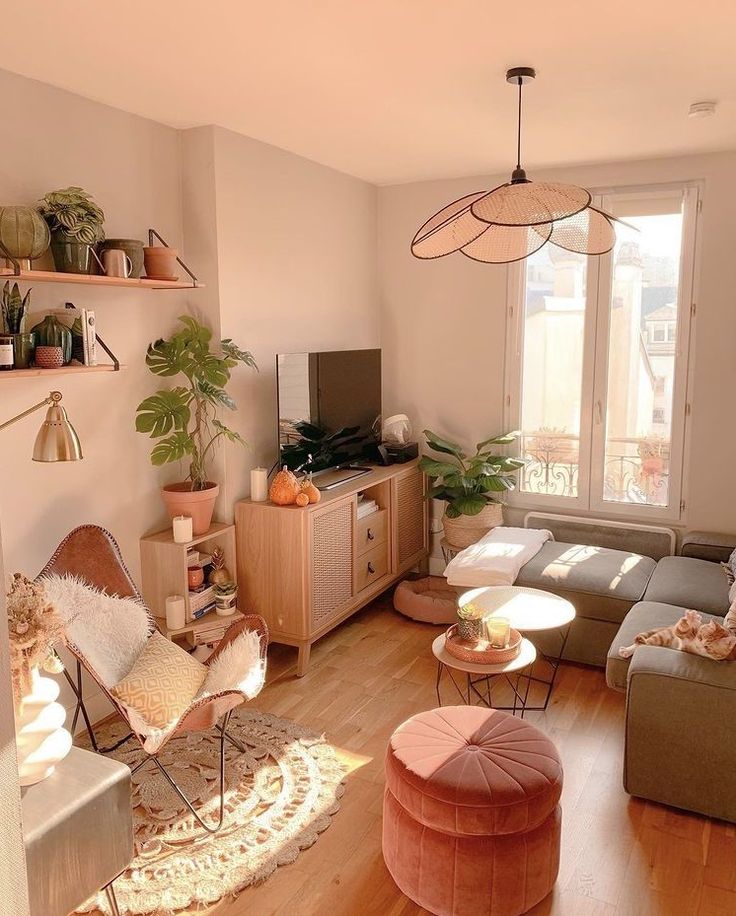 a living room filled with furniture and a flat screen tv sitting on top of a wooden floor