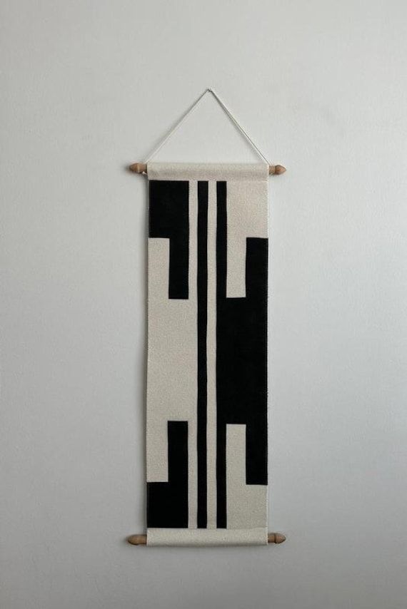 a black and white wall hanging on the wall