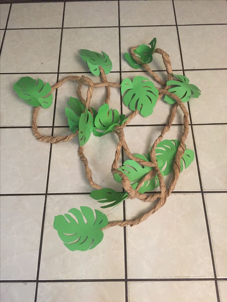 a piece of paper that has been cut out to look like leaves on a tile floor