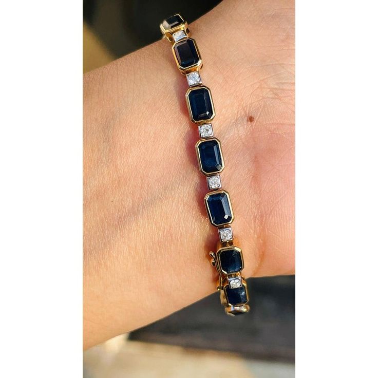 Blue sapphire and Diamond bracelet in 18K Gold. It has a perfect octagon cut gemstone to make you stand out on any occasion or an event. A tennis bracelet is an essential piece of jewelry when it comes to your wedding day. The sleek and elegant style complements the attire beautifully, whether it's the bride wearing it herself, or as a gift to her bridesmaids to wear on the D’day.  Bracelets are worn to enhance the look. Women love to look good. It is common to see a woman rocking a lovely gold bracelet on her wrist. A gold gemstone bracelet is the ultimate statement piece for every stylish woman.  PRODUCT DETAILS :-  > Material - 18K Solid Yellow Gold > Gemstone - Blue Sapphire    > Stone Weight - 16.65 ct > Stone Shape - Octagon  > Stone Pcs - 19  > Stone Size - 6 x 5 mm > Diamond Weight Classic Diamond Gemstone Bracelet For Formal Occasions, Classic Gemstone Diamond Bracelet For Formal Occasions, Classic Diamond Bracelet With Gemstone For Formal Occasions, Classic Formal Diamond Bracelet With Gemstone, Yellow Gold Emerald Cut Tennis Bracelet For Formal Occasions, Emerald Cut Yellow Gold Tennis Bracelet For Formal Occasions, Emerald Cut Yellow Gold Tennis Bracelet For Formal Events, Formal Yellow Gold Emerald Cut Tennis Bracelet, Elegant Rectangular Tennis Bracelet With Baguette Diamonds