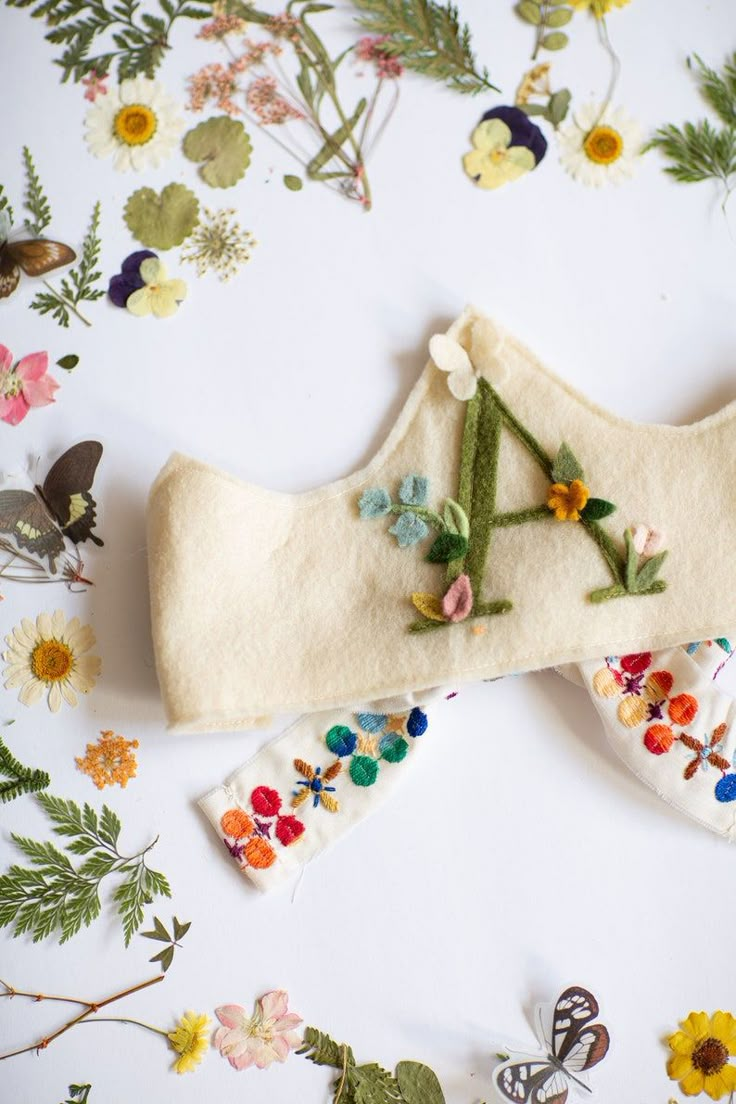 a pair of white socks with flowers and leaves on the bottom one is made out of wool