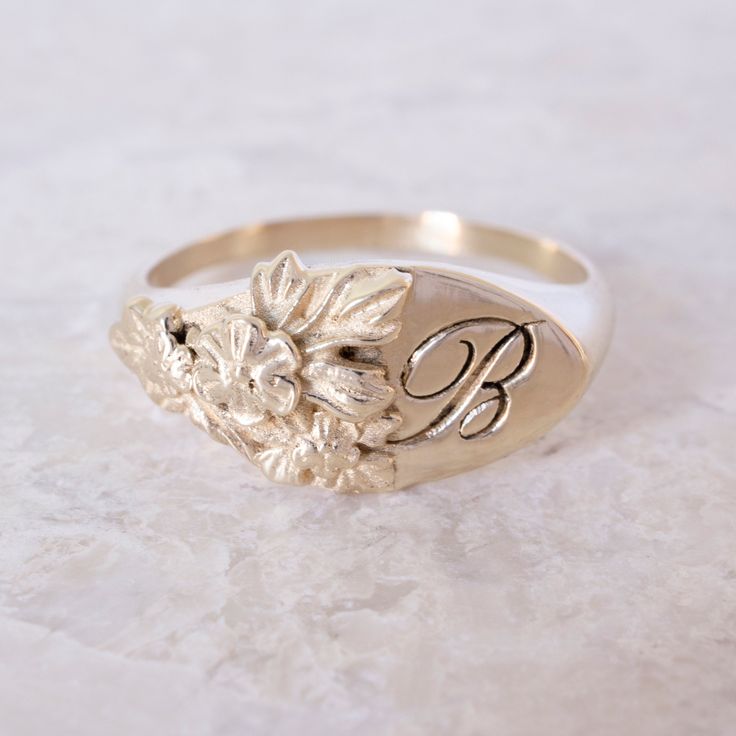 This vintage-inspired floral ring is a row of dainty flowers wrapped around your fingers. Handmade and polished, it is available in solid 8K and 14K gold. This item is engravable with text or monogram of your choice at no extra cost. The initals are engraved onto the ring and embedded in the 3D model for a flawless embossed finish. It is also possible to add a diamond or birthstone or diamond to this ring at an additional fee. Please inquire for details. A few notes about our gold: - Though we d Luxury Wedding Signet Ring With Single Diamond, Luxury Gold Signet Ring With Diamond Accents, Luxury Brilliant Cut Engraved Ring, Luxury Art Deco Signet Ring As A Gift, Luxury Gold Signet Ring With Halo Setting, Luxury Vintage Signet Ring With Diamond Accents, Luxury Art Deco Signet Ring For Gift, Luxury Antique Engraved Ring For Commemoration, Luxury Ceremonial Hallmarked Signet Ring