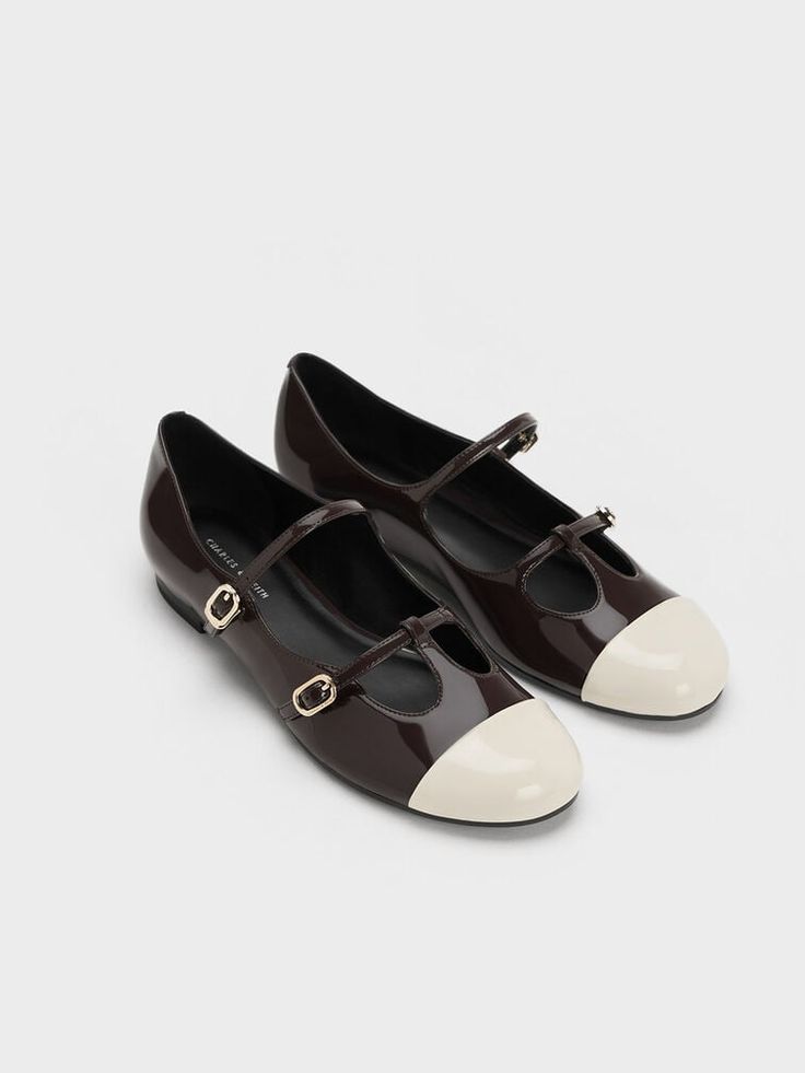 Refreshing the ever-popular Mary Jane style for a contemporary feel, this pair will be a worthy addition to your collection. The Mary Jane silhouette is adapted for visual interest with double buckled straps and a T-bar design, which stands out even more with the two-toned design. The versatile dark brown finish is topped off with white toe caps for a truly eye-catching look. Retaining classic elements like rounded toes and low block heels, these shoes blend timeless sophistication with modern details. Faux Leather Heels, Charles Keith, Low Block Heels, Pretty Shoes, Boot Sandals, Sock Shoes, New Shoes, Mary Janes, Me Too Shoes