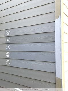 the side of a house with numbers and arrows pointing in different directions on it's siding