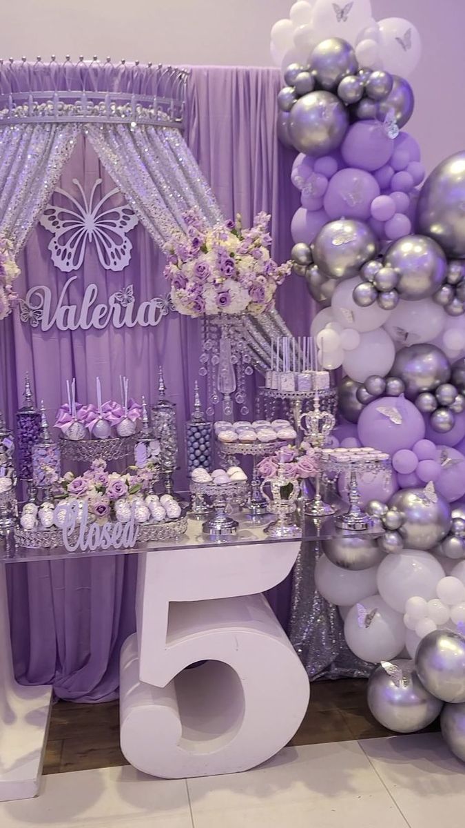 a purple and silver themed birthday party with balloons