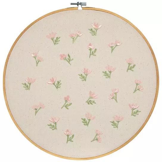 a white wall hanging with pink flowers on it