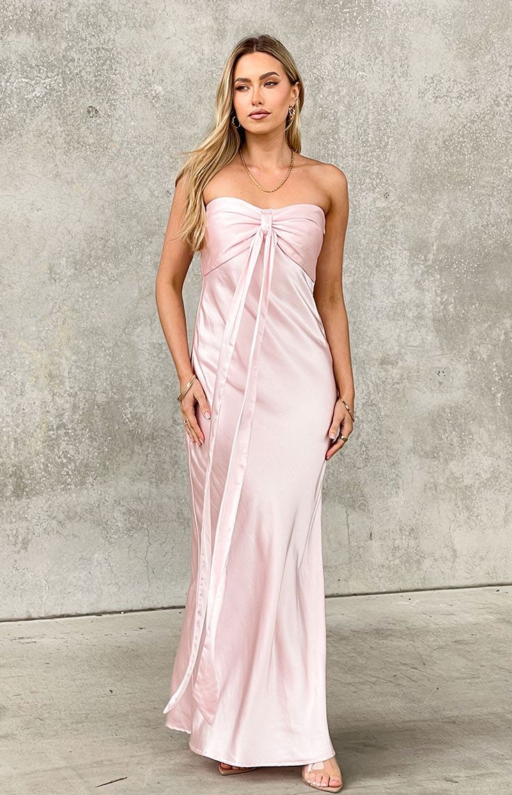 Light Pink Strapless Maxi Dress

How to style:
Take a formal () occasion to the next level in the luxe satin strapless maxi dress (). This thick baby pink material is stunning - you'll be radiating all night long. Pair with kitten heels and dainty jewellery () as the finishing touch.

Features:
  
 * Maxi length 
 * Strapless style  
 * Inner bust gripping 
 * Sweetheart neckline 
 * Fully lined 
 * Slight stretch 
 * Invisible left side zip closure 
 * Centre bust gathering 
 * Ribbon draping feature at centre bust  
Please note: Ribbon feature can either be left or tied in bow for a femme touch! Light Pink Bridesmaids Dresses, Light Pink Midi Dress, Bridesmaids Pink, Light Pink Bridesmaid Dresses, 2024 Aesthetic, Dainty Jewellery, Prom Midi Dress, Quince Dress, Hoco Dress