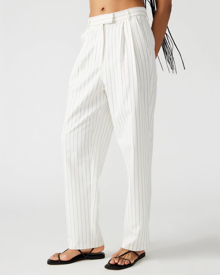 Elevate your spring wardrobe with the RUMI pant. These pinstripe suiting trousers are menswear inspired and feature a tapered design and pleated detailing. These trousers offer a sophisticated and polished look for any occasion. Pinstripe pleated trousers Hook and bar closure with zipper 2 functional side pockets and 2 functional back pockets 63% polyester 35% rayon 2% elastane Inseam: 29" Care instructions: hand wash cold separately, do not bleach, lay flat to dry, low iron if necessary, or dry Pleated Trousers, Menswear Inspired, Spring Wardrobe, Low Iron, Rumi, Polished Look, Lay Flat, White Black, Care Instructions