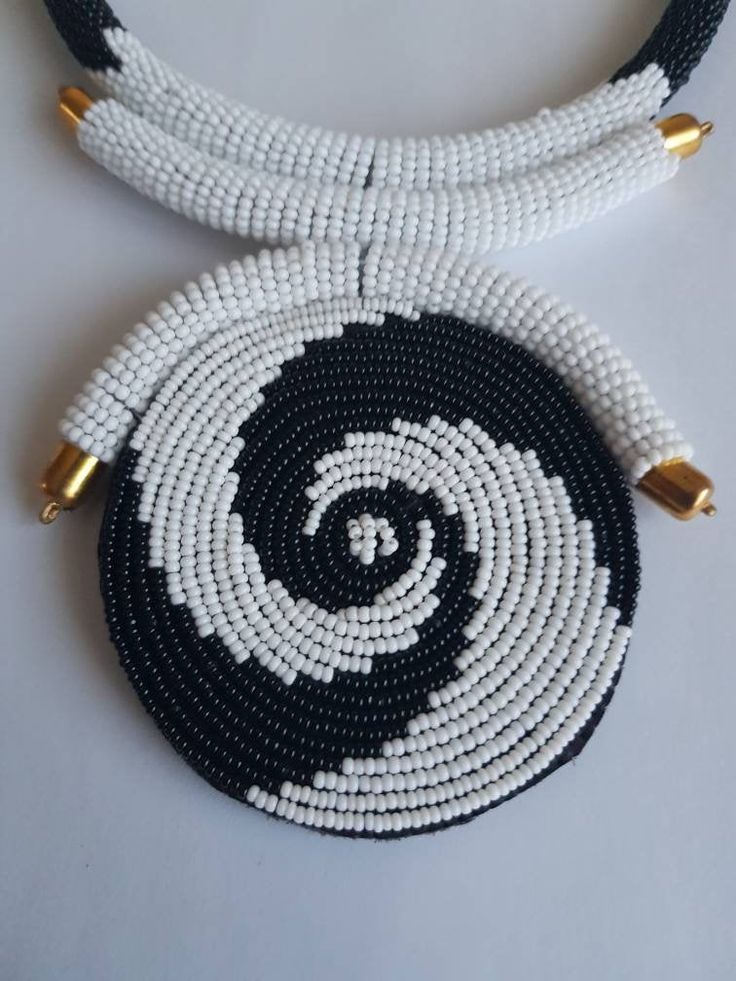 "This necklace is 100% handcrafted using white and black beads. Measurements: 18 inches around the neck. Pendant: 4\" Perfect for weddings, African themed events, traditional events etc. **Buy multiple items and pay shipping for 1 item only.The rest ships free. More neckleces here; https://www.etsy.com/shop/TribalTess?ref=seller-platform-mcnav&section_id=21306083 Back to my shop; https://www.etsy.com/shop/TribalTess?ref=seller-platform-mcnav" White Beaded Necklaces With Large Beads, White Beaded Necklaces With Black Beads For Gifts, White Beaded Necklace With Large Beads, Neck Pendant, White Beaded Necklace With Large Round Beads, Unique White Jewelry With Black Beads, Handmade White Beaded Round Necklace, White Necklaces With Black Beads, White Beaded Necklaces With Black Beads As Gift