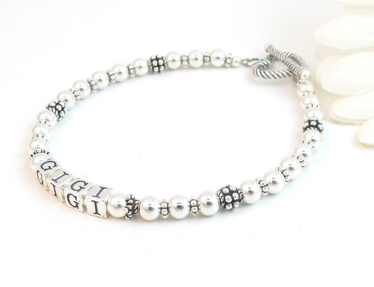 "Beaded Name Bracelet: Created with 4.5mm sterling silver alphabet blocks, 5mm sterling silver balls, and handcrafted sterling silver accent beads.  The name on the bracelet can be hers, her child or grandchild's name, or something like Nana, Mimi, Grandma, Mommy, etc. The beads are strung on super strong, stainless-steel wire for extra durability. Note: the handcrafted accent beads may vary (The Gigi bracelet and video shows the most current stock) The base price includes 6 letters.  Each addit Mom Bracelet, Nana Grandma, Silver Beaded Bracelet, Alphabet Blocks, Sterling Silver Bead Bracelet, Moms Bracelet, Silver Bead Bracelet, Birthstone Bracelets, Real Pearls