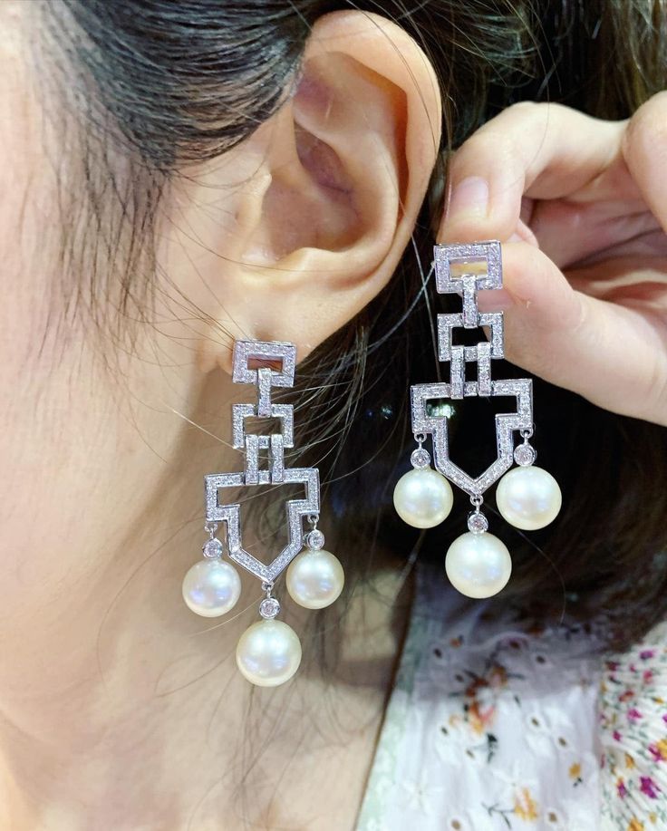 We are presenting you a HUGE pair of ONE OF A KIND, CHANDELIER, Genuine, CLASSIC WHITE South Sea Pearls, extremely FINE AA+, LUSTROUS and Rare! Accenting the 6 pearls are 144 pieces of E/VS Natural diamonds, weighting a total of 1.64 carats. Set in fabulously designed 18K solid white gold earrings! TIMELESSLY CLASSIC! WITH GORGEOUS Art Deco DESIGN. ONLY ONE ITEM AVAILABLE!! NO DUPLICATES!! WHAT YOU SEE IN THE PICTURES IS WHAT YOU WILL GET SOLIDLY HANDCRAFTED EARRINGS! SUGGESTED RETAIL VALUE: $10 Elegant Round Chandelier Earrings With Diamond Accents, Luxury Diamond White Chandelier Earrings, Luxury Chandelier Earrings With Diamond Accents For Anniversary, Luxury Chandelier Earrings For Formal Occasions, Elegant Diamond Accented Drop Chandelier Earrings, Luxury Diamond White Chandelier Earrings With Elegant Design, Elegant Diamond Accent Drop Chandelier Earrings, Luxury White Gold Chandelier Earrings With Elegant Design, Luxury Chandelier Earrings In Diamond White With Elegant Design