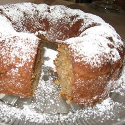 a cake that has been cut in half and is on a plate with powdered sugar