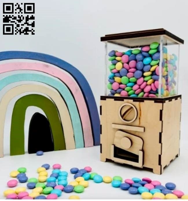 a toy oven with candy in front of it and a rainbow next to it on a table