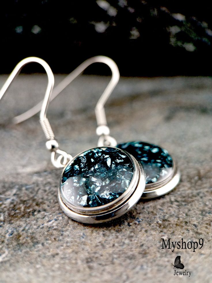 ➣ Product Description: Discover timeless elegance with our Elegant Ink Blue Crystal Earrings. These exquisite earrings feature real crushed ink blue crystals encased in clear resin, set within round stainless steel settings. Ink blue crystals are associated with wisdom, depth, and tranquility, making these earrings perfect for those who appreciate serene and sophisticated beauty. The deep blue hue of the crystals adds a touch of refinement to any outfit, while the durable and hypoallergenic stai Crystals In Resin, Shattered Art, Blue Crystal Earrings, The Last Picture Show, Earring Stand, Shattered Glass, Broken Glass, Ink Blue, Handcrafted Art