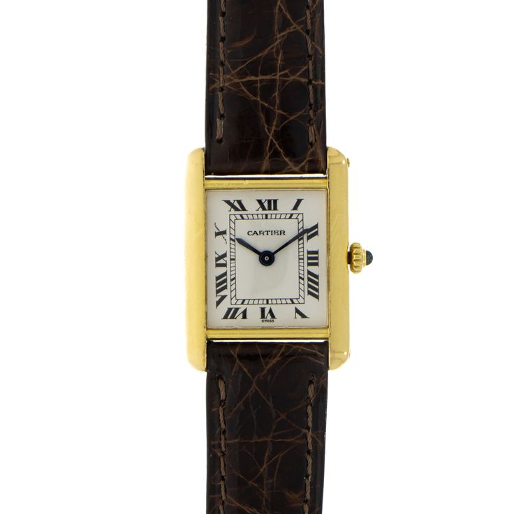 Pre-owned in good condition lady’s Cartier Tank small size, quartz movement, silver dial with Roman numerals, blue sapphire cabochon crown, sapphire crystal on a leather strap with a yellow gold cartier tang buckle. The watch shows signs of wear. This watch has box and papers. Classic Watches With Gold-tone Hardware And Rectangular Dial, Elegant Formal Watches With Gold-tone Hardware, Classic Formal Jewelry With Gold-tone Hardware, Elegant Gold Watches For Formal Occasions, Classic Yellow Gold Watch With Gold-tone Hardware, Timeless Yellow Gold Watches With Gold-tone Hardware, Classic Yellow Gold Watch, Formal Gold-tone Watch With Rectangular Dial, Classic Formal Watches With Gold Clasp