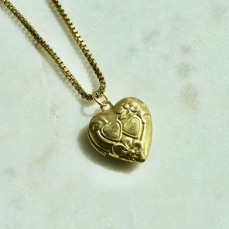 Gold Heart Necklace With Box Chain, Antique Gold Heart Pendant Vintage Necklace, Vintage Antique Gold Heart Pendant Necklace, Brass Medallion Locket Necklace With Adjustable Chain, Antique Gold Brass Necklace For Keepsake, Gold Heart Shaped Box Chain Jewelry, Vintage Gold Heart Charm Necklace, Vintage Gold Heart Pendant Necklace, Gold Brass Locket Necklace