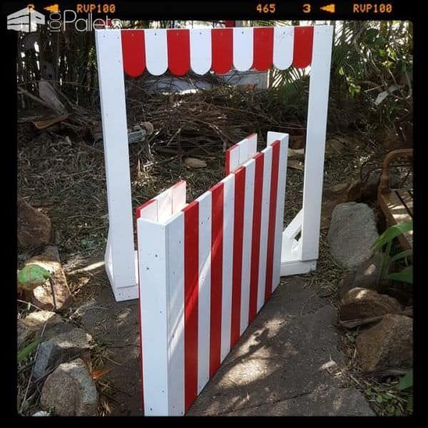 a red and white striped gate on the ground