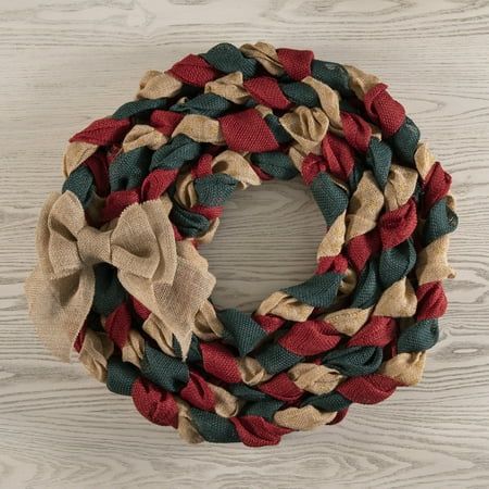 a red, green and tan wreath on a wooden surface