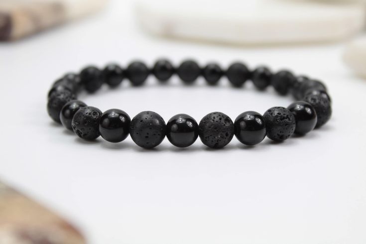 Show your special someone you care with a unique, handmade bracelet. This bracelet is crafted with Lava Stone and Obsidian beads to create a timeless, beautiful accessory they can wear anywhere.  You can check all our available sizes on the product pictures where you can find out the right size to fit any wrist. Bracelet is stretchy fit and I suggest you to measure your wrist size.  To measure your wrist size,wrap a string around your wrist then measure against a ruler and add aprox. 1-1.5 cm ex Friendship Bracelets With Black Round Beads, Casual Beaded Bracelets With Black Beads As Gift, Black Gemstone Beads Wristband Gift, Black Gemstone Beads Wristband, Casual Black Beads Stretch Bracelet Gift, Casual Black Beads Stretch Bracelet, Spiritual Black Beads Bracelet For Gift, Black Beads Bracelet Wristband Gift, Spiritual Black Beads Wristband As Gift