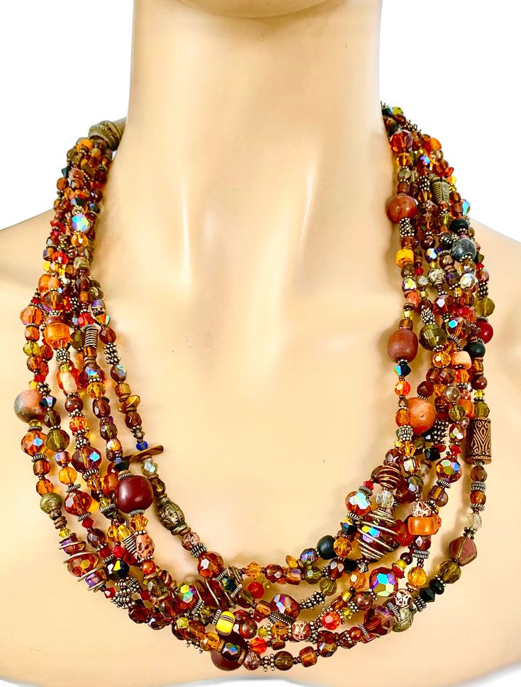 I believe this necklace was made with vintage and new beads. The closure is typical of vintage ethnic jewelry but some of the beads are certainly not too old. The video shows how sparkling the piece is. Mixed Materials, a few Agate beads, and what seems to be some tiny Carnelians Length: 24 inches 6 strands Weight: 9.7 ounces Vintage Multi-strand Beaded Necklace With Polished Beads, Vintage Multi-strand Beaded Necklaces, Vintage Multi-strand Colorful Beaded Necklaces, Vintage Multi-strand Beaded Necklaces With Colorful Beads, Vintage Multi-strand Beaded Necklace, Vintage Multi-strand Beaded Necklace With Colorful Beads, Vintage Style Polished Beads Necklace, Vintage Multi-strand Jewelry With Large Beads, Bohemian Double Strand Faceted Beads Necklace